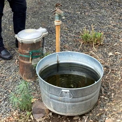 image of a water spigot over a water trough